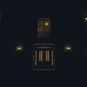 A tense and dark atmosphere of a luxurious townhouse related to a disturbing kidnapping case.