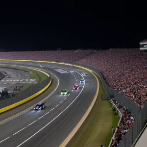 NASCAR cars racing at night at Bristol Motor Speedway