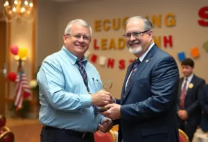 A school superintendent being honored with an award at a ceremony.