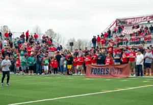 Fans cheering at a high school football game between Virginia High and Tennessee High