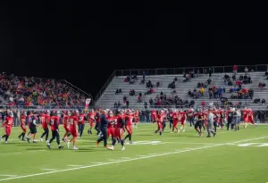 High school football teams Virginia High Bearcats and Tennessee High Vikings warming up before the game.
