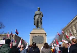 Statue representing the memorialization of a public figure in a political context.